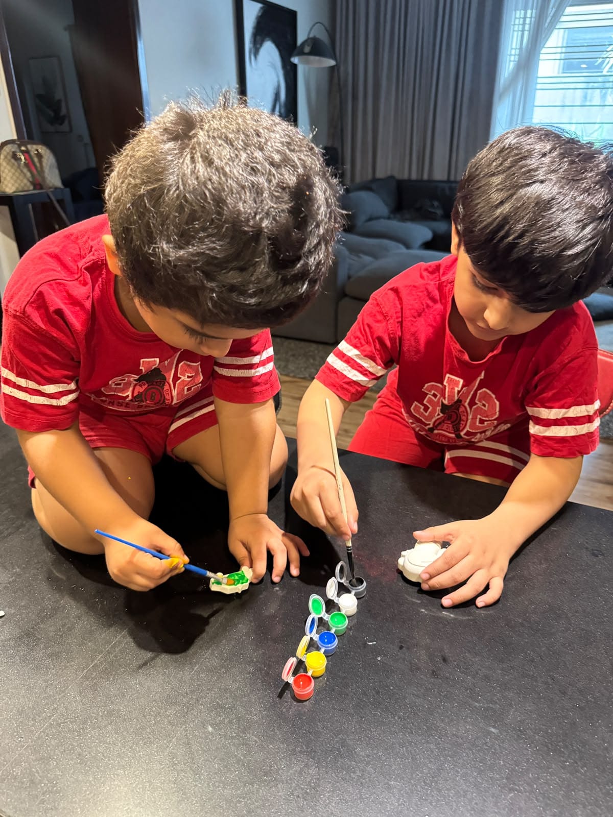 Toddlers painting their own toys